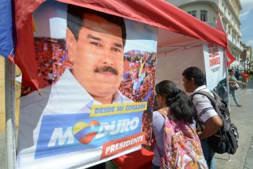  The December 6 elections are critical to President Nicolas Maduro's, pictured on poster, socialists remaining in power. - AFP Photo