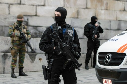 © Belga/AFP/File | Belgian security forces stand guard outside the Brussels Palace of Justice on November 20, as two terror suspects appeared to answer charges in connection over the terror attacks in Paris