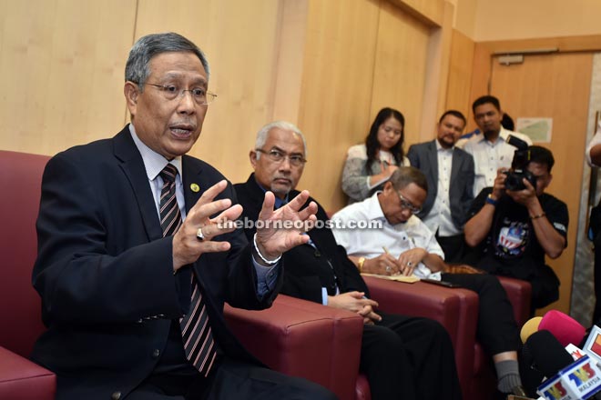 Abdul Aziz (left) explaining a point to reporters during the press conference.