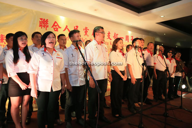 UPP Batu Kawah branch committee members singing their party song during their branch’s first anniversary celebration. — Photo by Kong Jun Liung