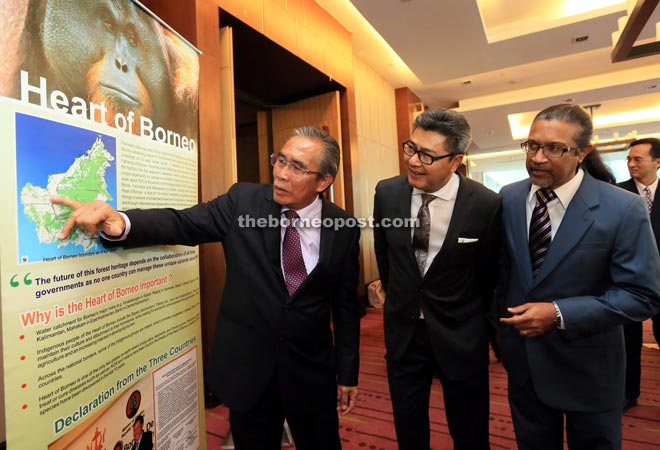 Len (left) pointing on a spot in the HoB map while Sudarsono (second left) and WWF-Malaysia chief executive officer Datuk Dr Dino Sharma look on.