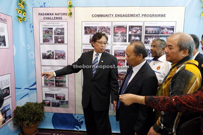 (From left) Abang Johari, Nansian, Daud and others check items at the exhibition hall. — Photo by Chimon Upon