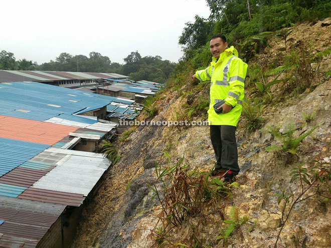 A police officer investigates the landslide.