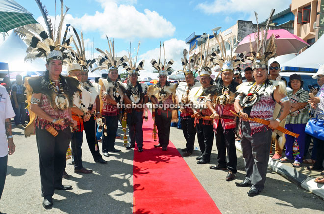Members of Sarawak Dayak National Union (SDNU) welcome the Chief Minister in traditional Iban costumes.