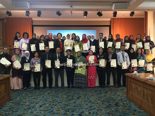 Fatimah (second row, seventh left) together with OSTPC members who have just received their letters of appointment. 