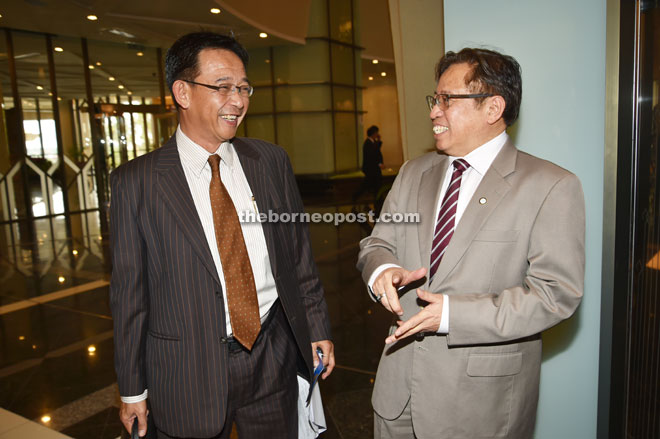 THAT’S HILARIOUS: Assistant Minister of Housing Datuk Abdul Karim Hamzah (left) shares a light moment with Housing Minister Datuk Amar Abang Johari Tun Openg prior to attending the State Legislative Assembly (DUN) sitting yesterday. — Photo by Tan Song Wei