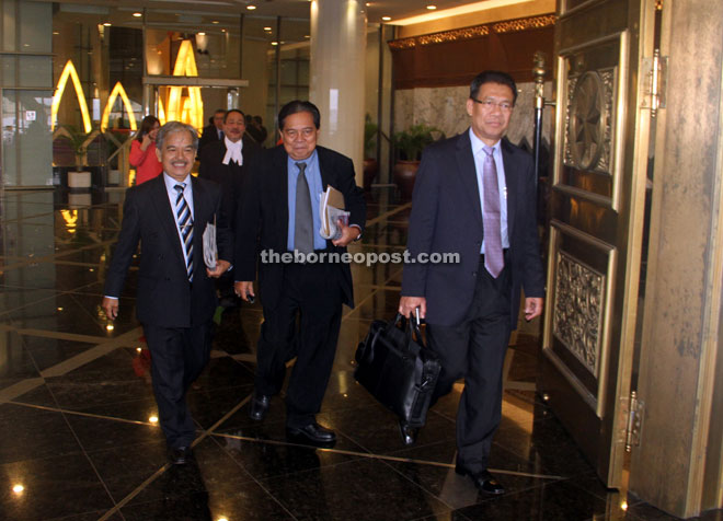 ALL SMILES AFTER JOB DONE:(From left) Paulus Palu Ngumbang (BN-Batu Danau), Ranum Mina (BN-Opar) and Datuk Julaihi Narawi (BN-Sebuyau) walk out of the complex together.