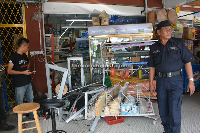 A policeman walks past the mess left by the accident. 