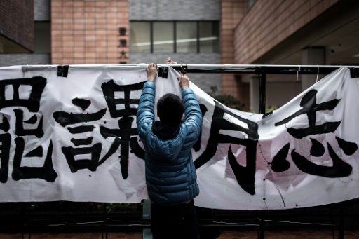 A student sets up a banner during a rally at Hong Kong University on January 20, 2015 protesting against the appointment of Arthur Li, known to be close with the government, as chairman of the university's governing council last month. - AFP Photo 