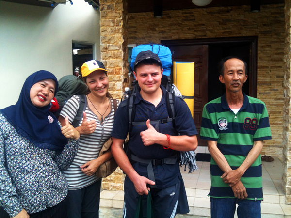 The couple with a family who hosted them in Brunei.