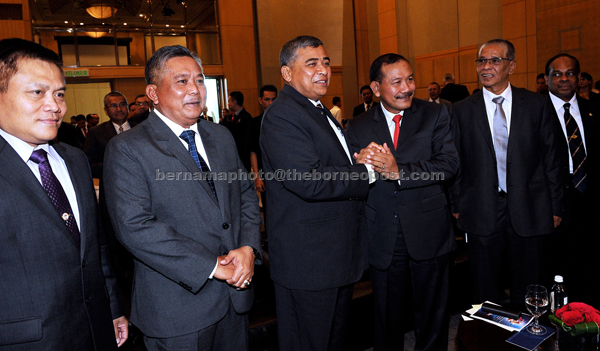 Khalid (third left) greets Indonesian National Police chief, General (P) Drs Badrodin Haiti (third right) at the handing and taking over of duties ceremony of ASEANAPOL police secretariat at a hotel in the capital. Also present are (from left) incoming executive director  Brigadier General (P), Yohanes Agus Mulyono of Indonesia,  outgoing executive director, SAC Pengiran Datuk Paduka Abdul Wahab Pengiran Omar of Brunei, Malaysian Deputy IGP Datuk Seri Noor Rashid Ibrahim and outgoing director for Police Services ASEANPOL, ACP Mohamad Anil Shah Abdullah of Malaysia. — Bernama photo