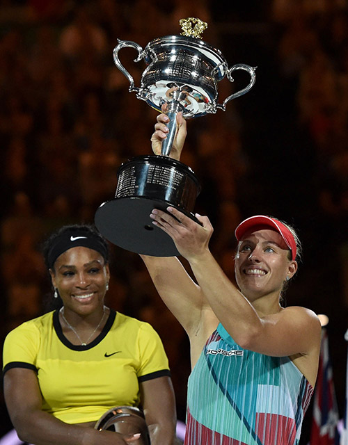 Germany’s Angelique Kerber holds The Daphne Akhurst Memorial Cup as she celebrates winning her women’s singles final against Serena Williams of the US. — AFP photo