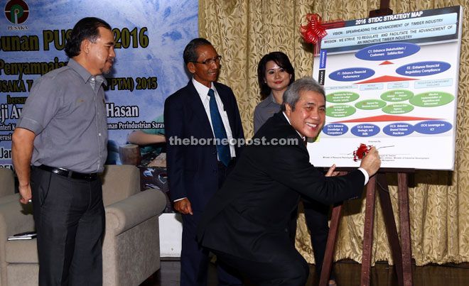 Awang Tengah signing the 2016 STIDC Strategic Map during the monthly meeting yesterday. From left are STIDC general manager Datu Sarudu Hoklai and his deputy Hashim Bojet. — Photo by Muhammad Rais Sanusi