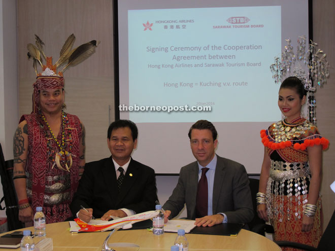 Ik Pahon (left) and Burke pose during the signing ceremony. 