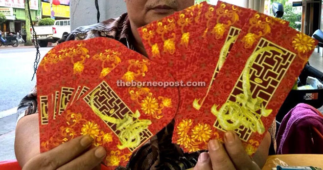 The angpow packets designed in red and gold of a bank.