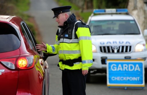 AFP/File | An Irish police officer operates a checkpoint in Wicklow, south of Dublin on December 10, 2015 