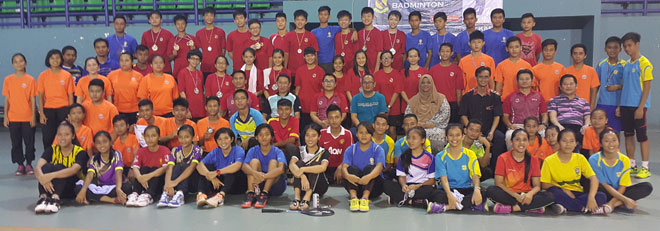 Badminton players and officials stand for a group album after the closing ceremony of MSS Inter-Secondary Schools Age-group Badminton Championships. 