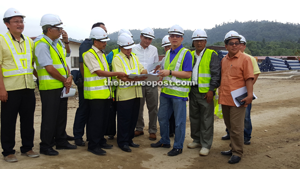 Fadillah (front, third right) accompanied by contractors during the site inspection.