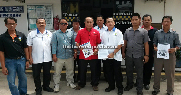 Changgai (fifth left) and Boniface (fourth left) with the group after filing the police report.