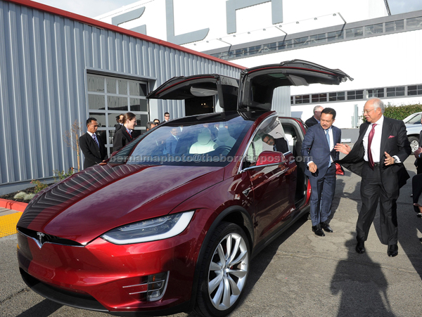 Najib (right) seems excited after having a test drive on the Tesla Model X during a tour of the electric car manufacturer plant. — Bernama photo