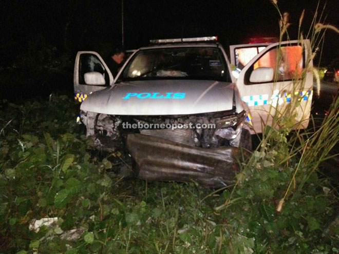 The wrecked police vehicle along the Sandakan-Telupid road.