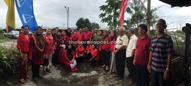 Dr Abdul Rahman (standing centre) pose for a photo with residents.