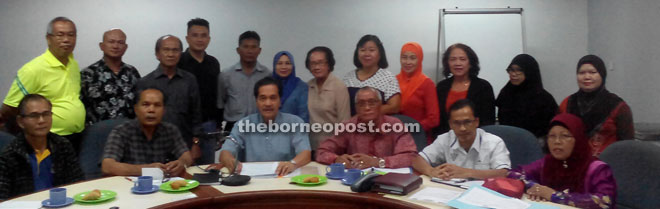 Gabriel (seated third left) flanked by Awang Raduan (fourth left) and Francis and other committee members in a photocall after the press conference. 