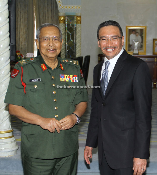 Adenan (left) and Hishammuddin share a light moment.