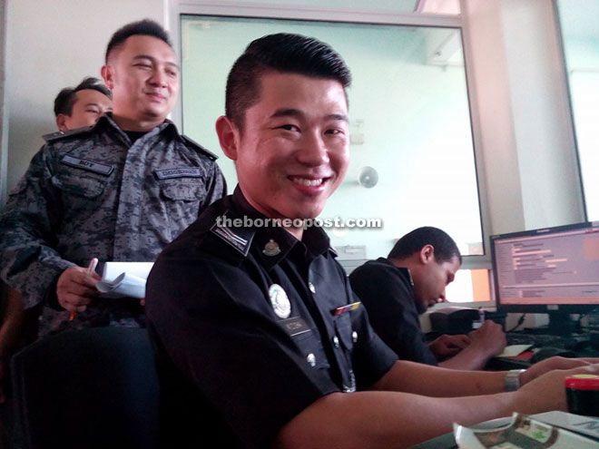 Roy (left) checks on an immigration counter at Sungai Tujuh. 