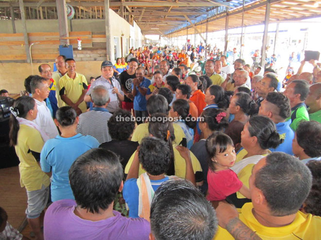 Entri (wearing cap) addresses the longhouse folk who come in full force to give him their support. 