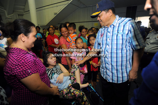 Shahidan (right) visiting the evacuation centre at Civic Centre in Kuching. — Bernama photo