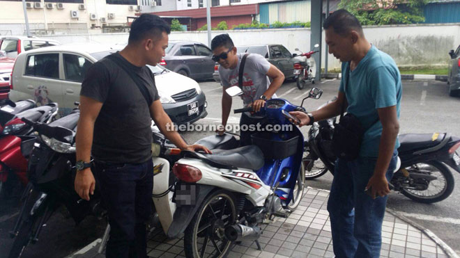 Police check on the motorcycle, which was reported missing last year.