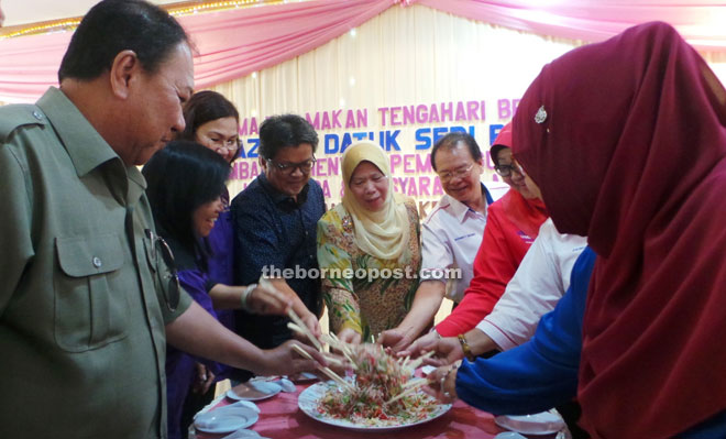 Azizah (centre), Ellron (fourth left), Rayner (sixth left) and Jubilin (left) together with the Pensiangan Women BN leaders doing the yee sang.  