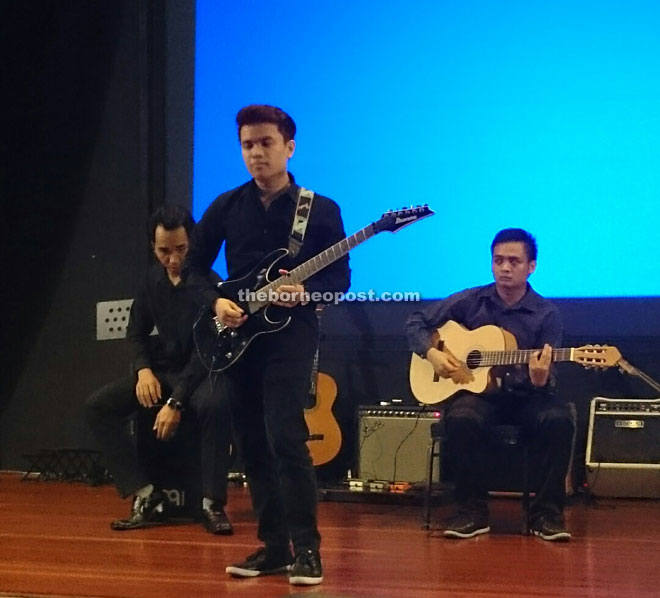 A student performing an electric guitar solo at MMTC.