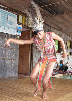 A youth performs a traditional Iban dance to welcome guests to Batang Ai.