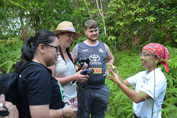 Ramona (right) describes a plant to a group of visitors during the nature walk.