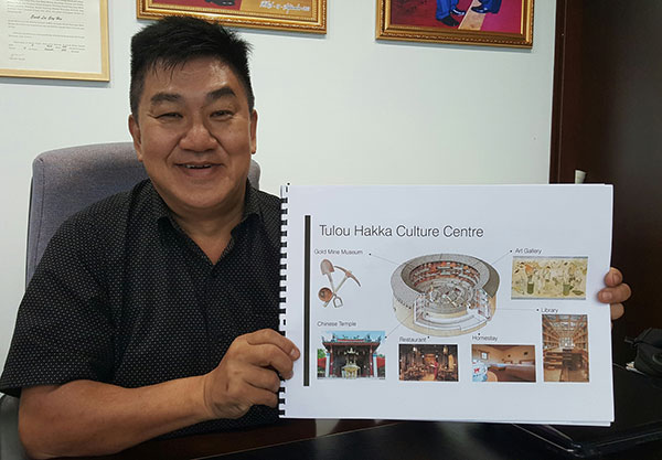Lee shows the plan of the Tulou Hakka Culture Centre.