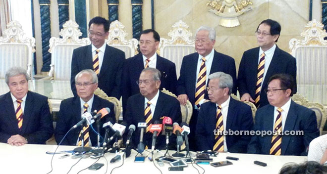 Adenan (seated centre) is seen at the press conference with cabinet members.