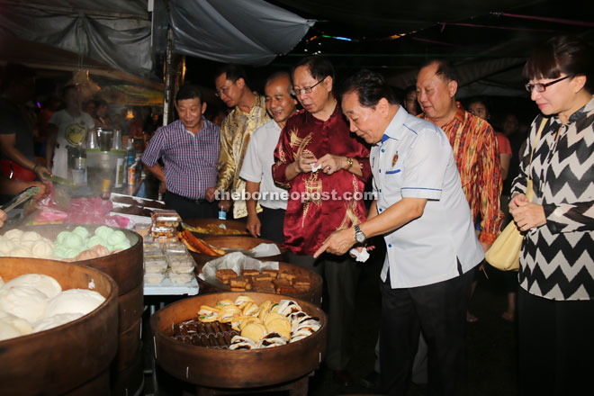 (From fourth left) Lau, Wong and others at a food stall. 