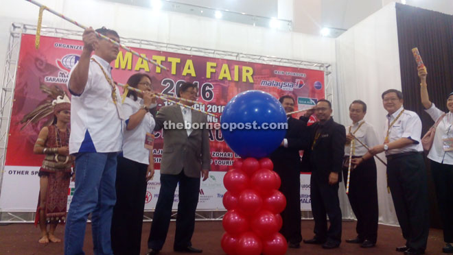 Abang Johari (third left), accompanied by Ik (fourth left) and others, preparing to officiate at the fair yesterday. 
