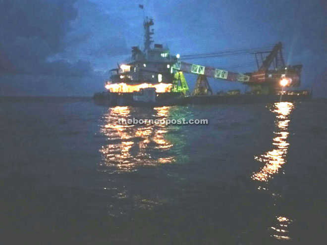 Shows the large ship with the crane and tugboat directly above the wreck of the Katori Maru.  