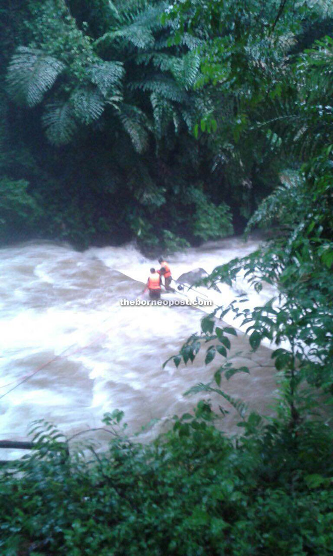 Firemen in the midst of rescuing the teenagers. 