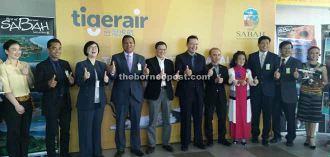 Pang (centre) and Kwan (fifth left) with Ng (third left), Joniston (fourth left) and other guests during Tigerair Taiwan’s inaugural flight launching ceremony at KKIA here yesterday.