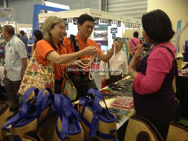 Singaporean visitors are fascinated by local Sarawak beads at the fair.