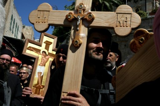 Serbian Orthodox Christian pilgrims carry wooden crosses along the Via Dolorosa (Way of Suffering), during the Good Friday procession in Jerusalem's Old City on April 29, 2016 -AFP