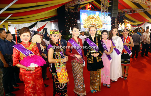 The finalists of a pageant contest dressed in full traditional attire of various races and tribes in Sarawak are seen in a photocall. 