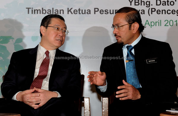 Mustafar (right) talking to Guan Eng after witnessing the signing of the Corporate Integrity Pledge. — Bernama photo