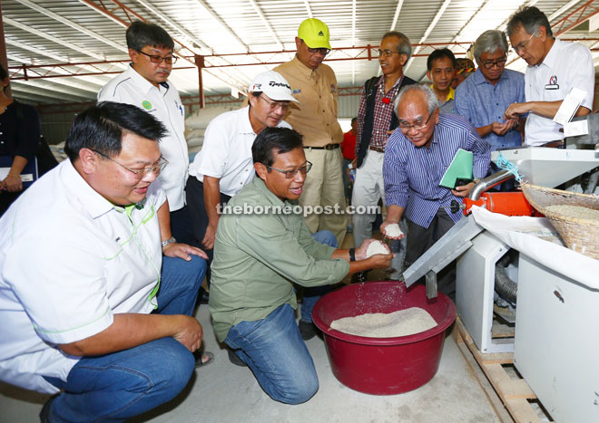 Ahmad Shabery listens to explanation on the processing of Bario Rice by representatives of Bario Ceria.