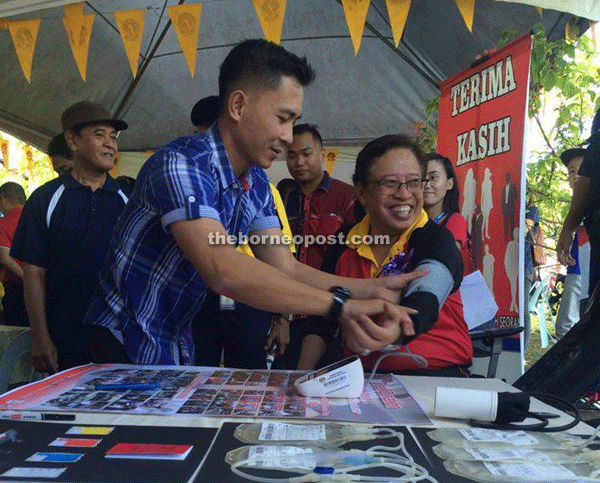 Abang Johari gets his blood pressure checked at a booth at the carnival.