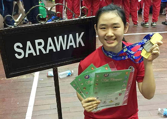 Alice Chang displaying her medals and prizes at the recent MSSM Table Tennis Championship in Kelantan.